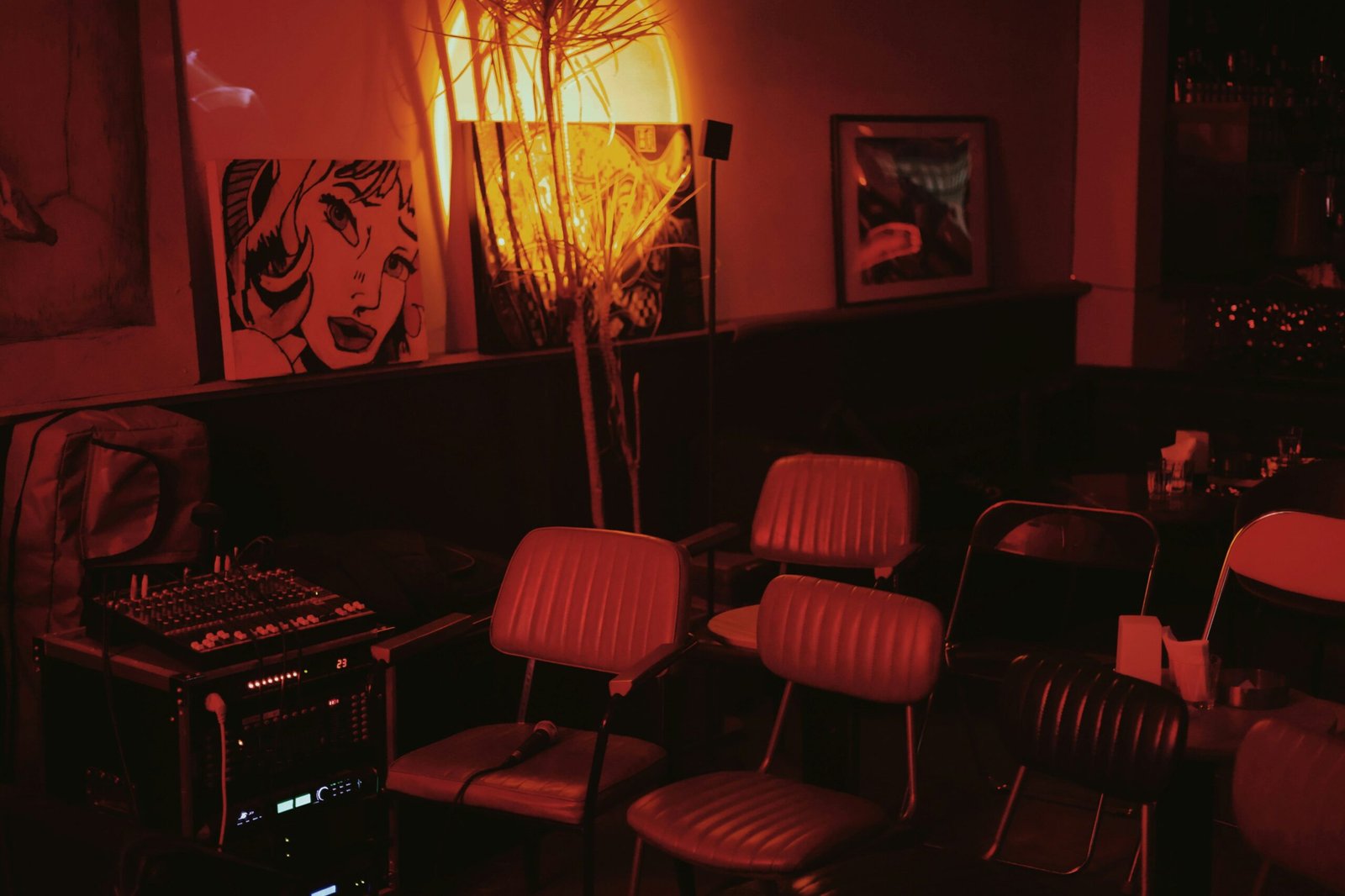 a room with chairs, a table, and pictures on the wall